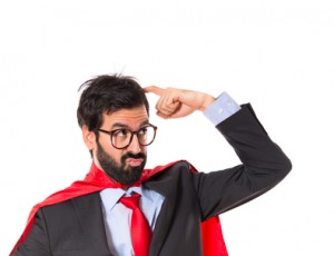 Businessman dressed like superhero thinking over white